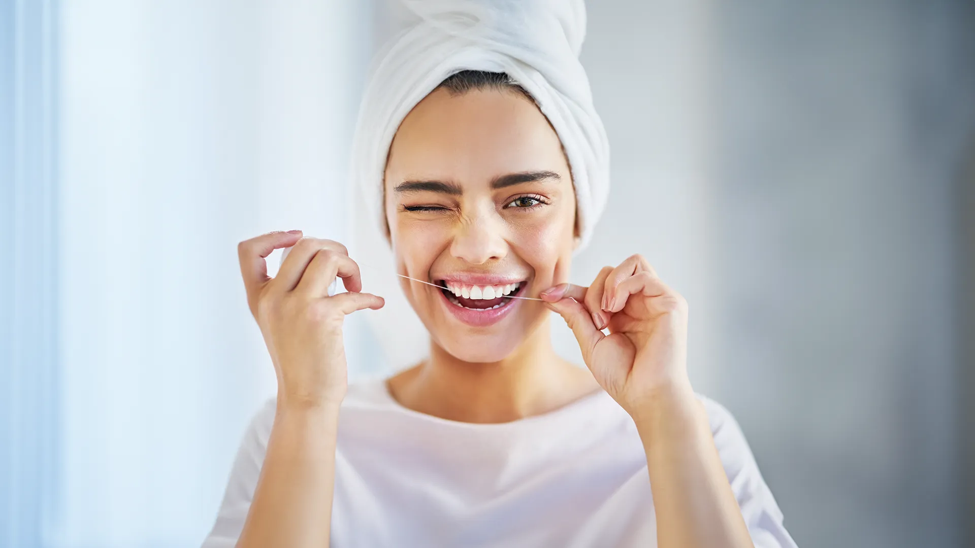 Woman flossing teeth